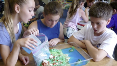 Students opening a sea-level-rise activity.