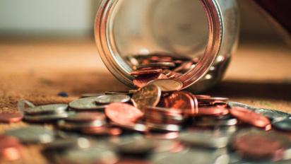 Coins spilling out of a jar