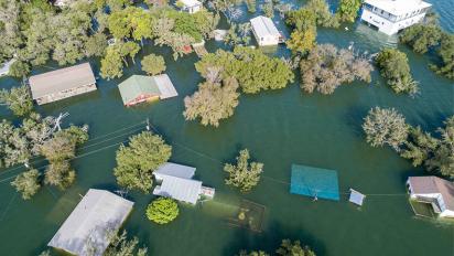 An aerial view of a neighborhood in Texas. Homes are underwater following a 