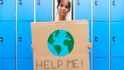 Student holding a climate change poster.