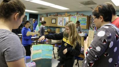 Director of Teacher Support Lin Andrews checking in with students