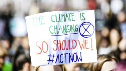 A sign saying "The climate is changing so act now"