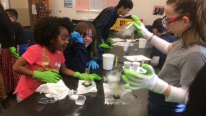 Kids doing an experiment at a table