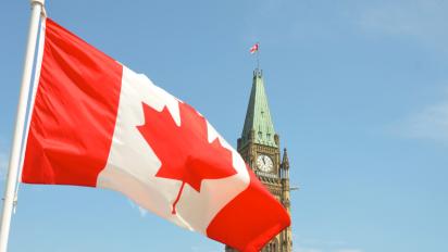 Flag of Canada in front of the Parliament Building in Ottawa.