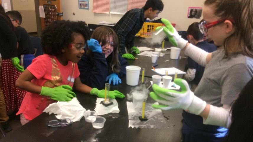 Kids doing an experiment at a table