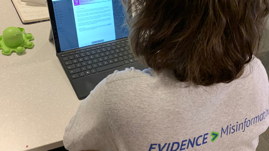 Teacher looking at laptop screen.