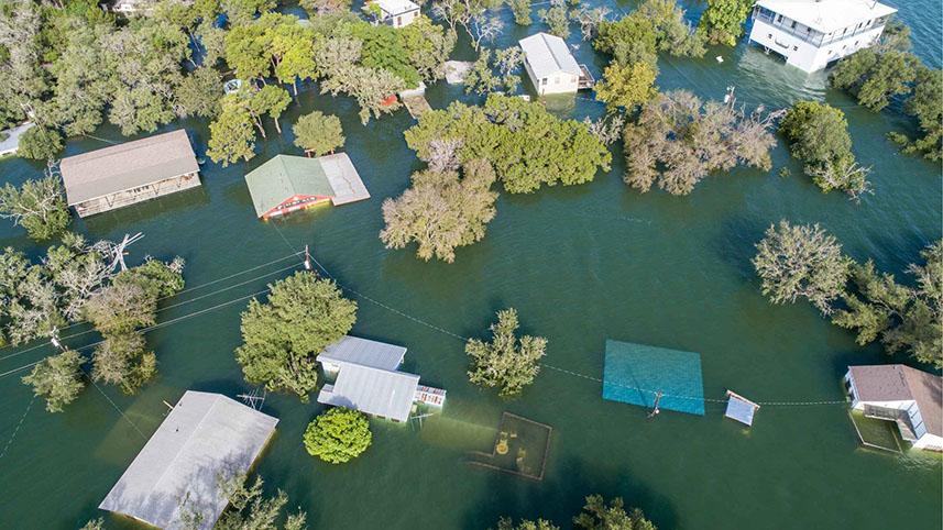 An aerial view of a neighborhood in Texas. Homes are underwater following a 