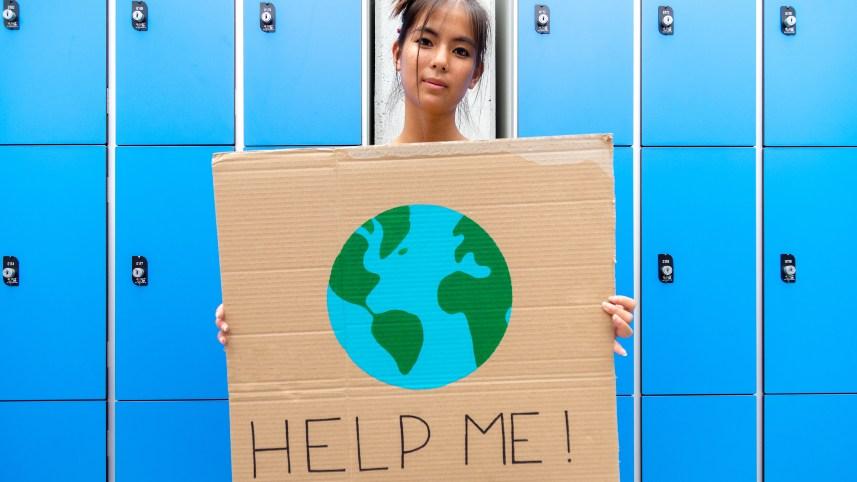 Student holding a climate change poster.