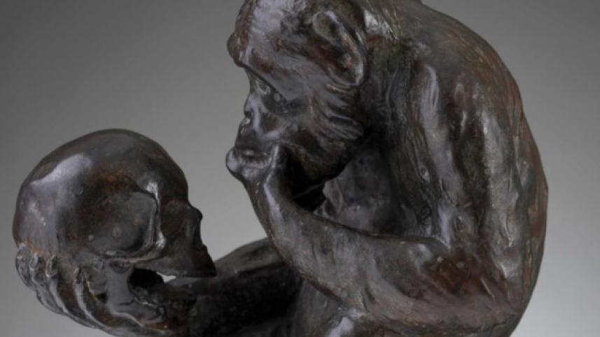 Monkey with human skull statue