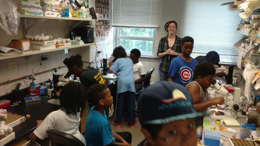 Teacher with students engaging in an experiment