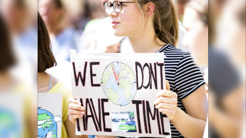 Young woman holding up a sign