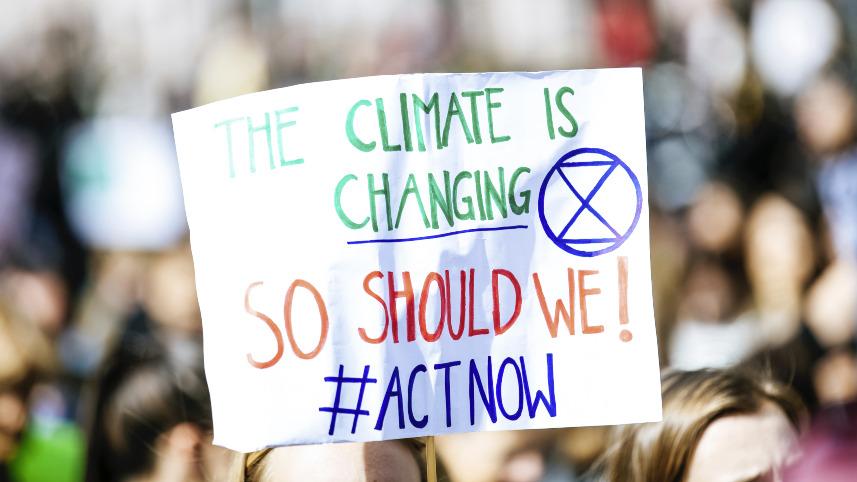 A sign saying "The climate is changing so act now"