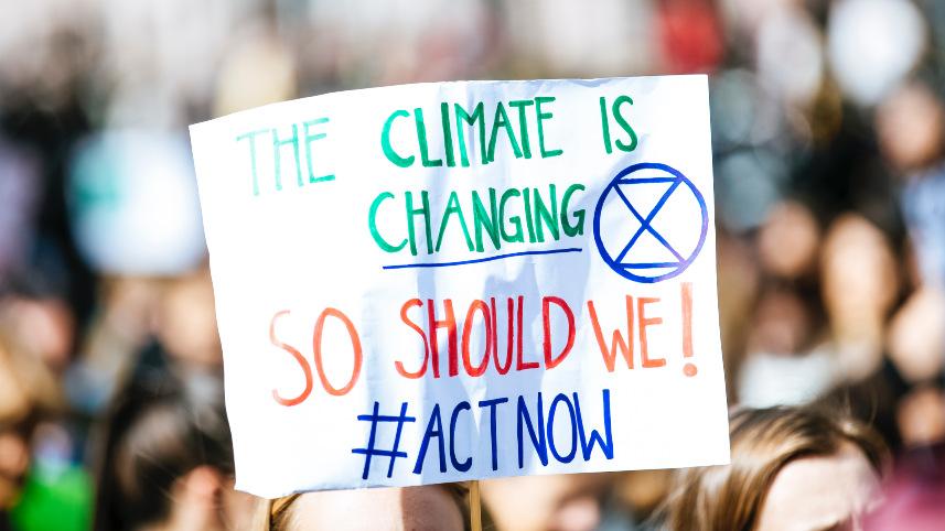Climate activitists holding a sign.