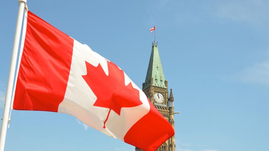 Flag of Canada in front of the Parliament Building in Ottawa.